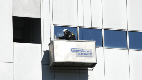 Un trabajador limpia los cristales de un edificio, en Madrid, a 21 de febrero de 2020.