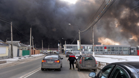 El humo negro se eleva hacia el cielo desde el mercado de Barabashovo, uno de los mercados más grandes de Europa del Este que cubre un área de más de 75 hectáreas, que supuestamente fue atacado por bombardeos, en Kharkiv el 17 de marzo de 2022, en med