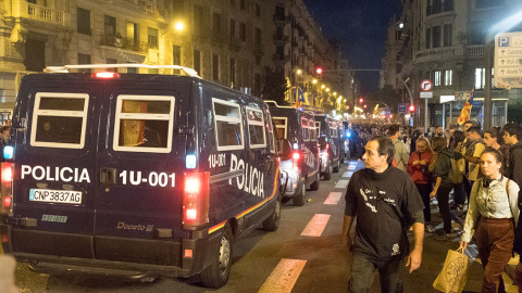 Las furgonetas de los antidisturbios de la Policía Nacional se retiran de Urquinaona, por Via Laietana, tras la pacificación de la revuelta. GUILLEM SANS