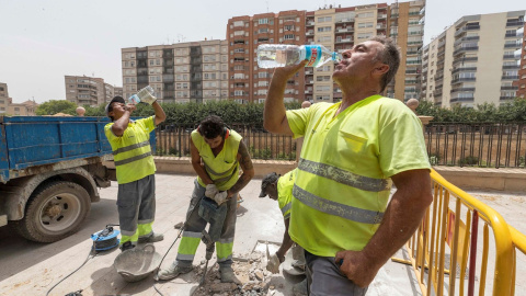 Trabajadores de la construcción beben agua en Murcia.