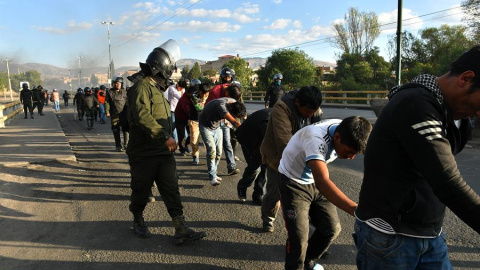 5/11/2019.- Policías bolivianos custodian a los detenidos luego de los choques con grupos de manifestantes este viernes, en Cochabamba (Bolivia).