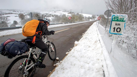 Un peregrino de Valladolid circula con su bicicleta por el kilómetro 10 de la carretera LU-663. EFE/Eliseo Trigo