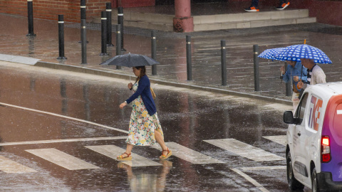 Varias personas se resguardan de la lluvia, ese jueves en Aragón