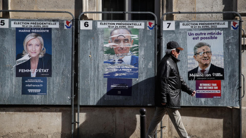 4/04/2022-Un hombre pasa junto a carteles que muestran a los candidatos presidenciales franceses en París, Francia, el lunes 4 de abril