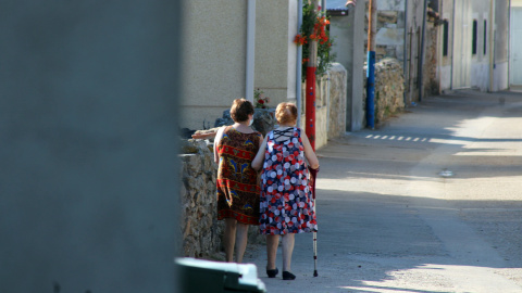 Castilla y León se vacía y envejece; en la imagen, dos mujeres mayores caminan por un pueblo de Salamanca