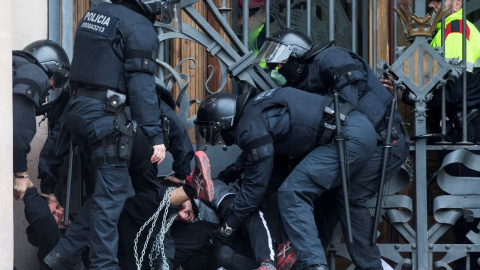 23 de febrero de 2018.- Los mossos cargan contra un centenar de personas encadenadas al TSJCat. EFE/Quique García