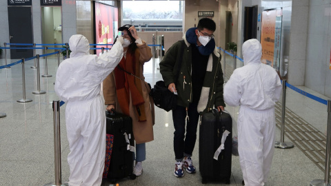 Trabajadores toman la temperatura a pasajeros de la estación de Xianning,  una ciudad que limita con Wuhan al norte. REUTERS