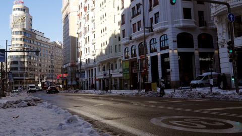 Vista de la nieve en las aceras de Gran Vía este martes en Madrid donde los colegios se encuentran cerrados, los supermercados desabastecidos y los hospitales intentando recuperar la normalidad tras días de aislamiento por el temporal Filomena, cuyo ras