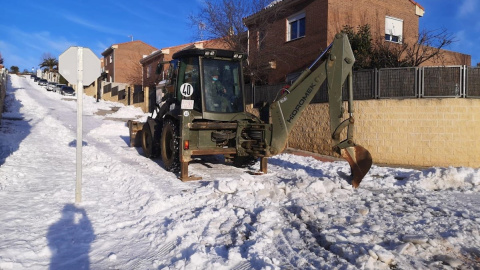 Una excavadora de la Brigada Extremadura XI del Ejército ayuda en la retirada de la nieve y el hielo de una calle de Guadalajara este jueves, tras el paso del temporal Filomena.