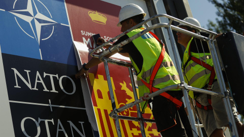 Dos operarios ultiman los preparativos alrededor de las instalaciones del recinto ferial IFEMA de Madrid este lunes con motivo de la cumbre de la OTAN que se celebrará en la capital.