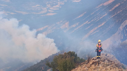 Un bomber observa un foc al Montsec, a Àger.