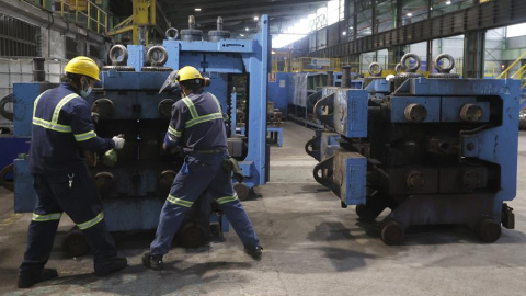 Dos trabajadores ante una máquina en las instalaciones de Sidenor.