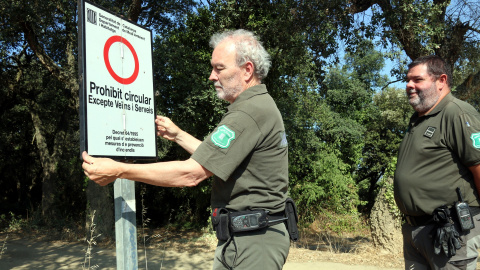 15/08/2022 - Agents rurals col·loquen un cartell sobre les restriccions d'accés a les Gavarres arran de l'activació del pla Alfa.