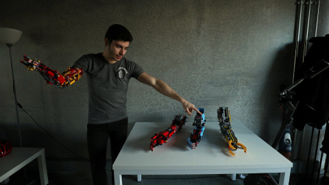 David Aguliar points at his prosthetic arms built with Lego pieces during an interview with Reuters in Sant Cugat del Valles, near Barcelona, Spain, February 4, 2019. Picture taken February 4, 2019. REUTERS/Albert Gea