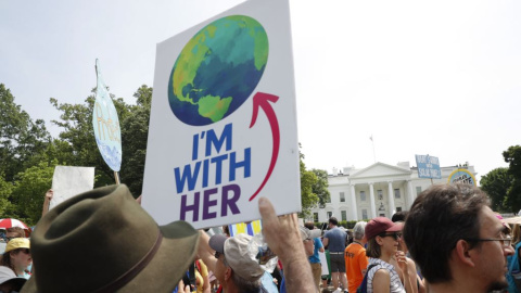 Participants walk along Pennsylvania Ave., infront of the White House in Washington, during a demonstration and march,Saturday, April 29, 2017. Thousands of people gather across the country to march in protest of President Donald Trump's environmental pol