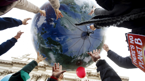 Manifestantes tiran un globo enorme con forma de mundo en la protesta de Roma, Italia, por el cambio climático. REUTERS/Alessandro Bianchi