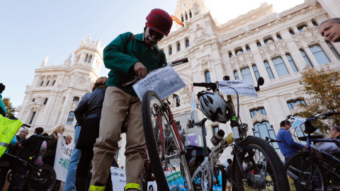 Una hombre se manifiesta con su bicicleta en favor del proyecto de Madrid Central a las puertas del Palacio de Cibeles.  EFE/Ángel Díaz