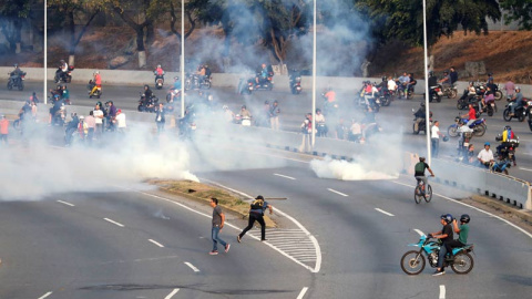 Lanzamiento de gases lacrimógenos en los alrededores de la base militar 'La Carlota' en Caracas. (REUTERS)