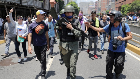 30/04/2019 - Un miembro de la Guardia Nacional de Venezuela tras de unirse a manifestantes antigubernamentales en una marcha, mostrando su apoyo al líder de la oposición Juan Guaidó en Caracas, Venezuela. / REUTERS - Manaure Quintero