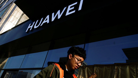 Imagen de un usuario de móvil frente a una tienda de Huawei. REUTERS