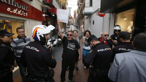 Un grupo de ciudadanos protesta durante la visita que ha realizado el presidente del Gobierno, Mariano Rajoy, por el centro de Benidorm. EFE/Manuel Lorenzo