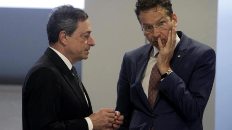 El presidente del Banco Central Europeo, Mario Draghi, habla con el presidente del Eurogrupo, Jeroen Dijsselbloem, durante la reunión del Ecofin en Riga. / VALDA KALNINA (EFE)