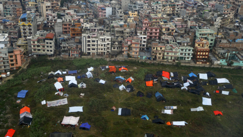 Los nepalís duermen en tiendas provisionales bajo lonas de plástico tras el terremoto del sábado, cerca del aeropuerto de Katmandú./ REUTERS-Wolfgang Rattay