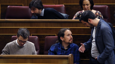 El diputado de IU, Alberto Garzón, conversa con el líder de Podemos, Pablo Iglesias, durante el pleno del Congreso. EFE/Kiko Huesca