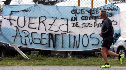 Un hombre pasa ante una bandera argentina colocada en la base naval de Mar del Plata. | REUTERS