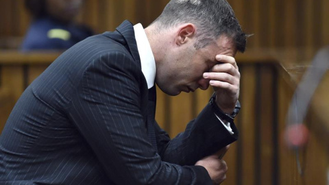 El atleta sudafricano Oscar Pistorius permanece sentado en el banquillo de los acusados durante una vista para dictar la pena que debe cumplir por el asesinato de su novia, en el Tribunal Superior del Norte de Gautengal en Pretoria, Sudáfri