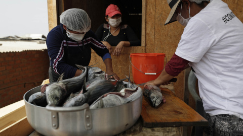 Unas mujeres preparan alimentos en el asentamiento humano de Buena Vista el 2 de febrero de 2021, en el populoso distrito limeño de Villa María del Triunfo, en Lima (Perú).