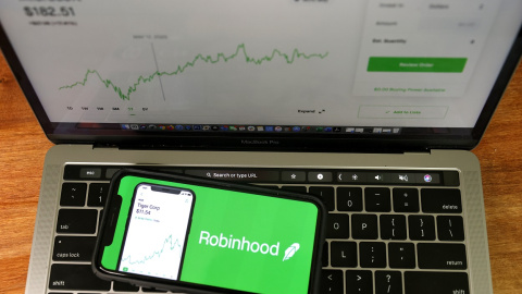 The Robinhood logo is displayed on an iPhone.