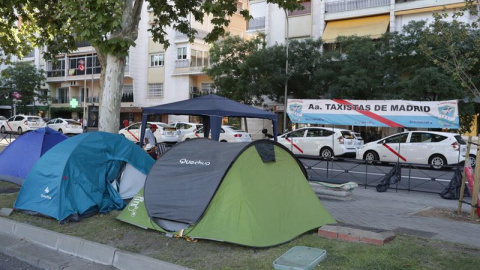 31/07/2018.- Concentración de taxistas en el Paseo de la Castellana, a la altura de Nuevos Ministerios hoy en Madrid. Las asociaciones del taxi Fedetaxi, Antaxi y Élite Taxi han anunciado que mantendrán la huelga que secundan en las princip