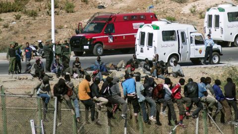 Inmigrantes subsaharianos encaramados en la valla de Melilla. REUTERS