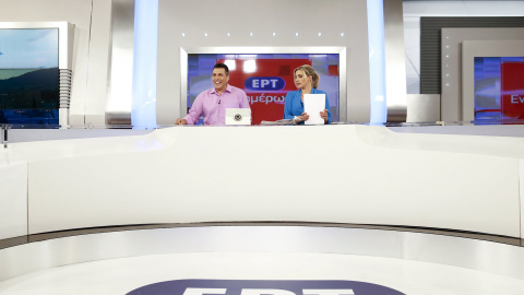 State television presenters Nikos Angelidis (L) and Vassiliki Haina prepare for the first broadcast of the station after its reopening./ REUTERS/Alkis Konstantinidis