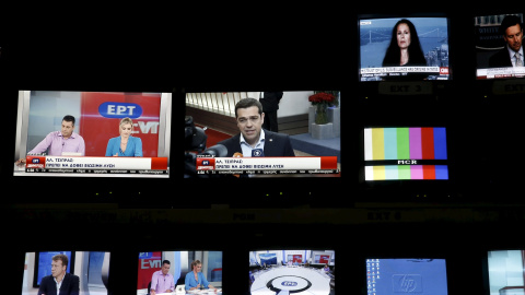 Greek Prime Minister Alexis Tsipras is seen on a monitor screen (C) at the control room during the first broadcast of state television ERT after its reopening./ REUTERS/Alkis Konstantinidis