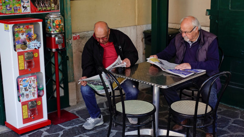 Dos pensionistas leen la prensa en un bar en Roma. REUTERS/Max Rossi