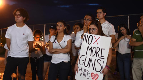 Decenas de personas oran este sábado, en la línea fronteriza de Ciudad Juárez (México), tras el tiroteo en un centro comercial de El Paso