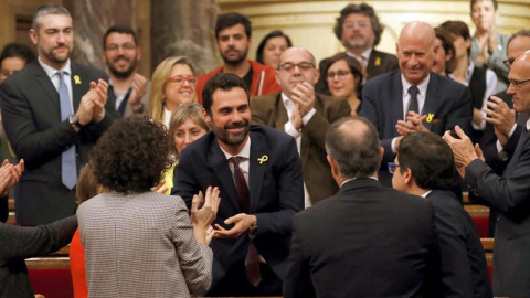 El nuevo presidente del Parlament, Roger Torrent (centro), recibe la felicitación de sus compañeros tras ser elegido durante la sesión constitutiva del Parlamento catalán de la XII legislatura. | EFE