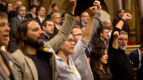 El diputado de la CUP Carles Riera (d) acompañado de los demás miembros de la formación cantan "Els Segadors", puño en alto, al finalizar el pleno de constitución que ha dado inicio a la XII legislatura. EFE/Quique García