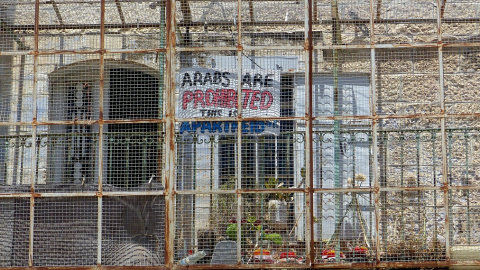 'Los árabes están prohibidos, esto es el apatheid', cartel en un balcón de la calle Shuhada - Leire Regadas - Julio 2019