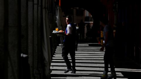 Un camarero con su bandeja en los soportales de la Plaza Mayor de Madrid. REUTERS/Sergio Perez