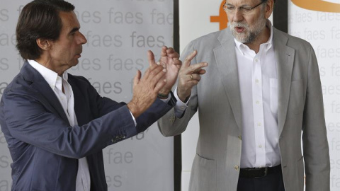 El presidente del Gobierno y del PP, Mariano Rajoy (d), junto al presidente de honor del PP y presidente de FAES, José María Aznar (i), durante la clausura del campus de verano organizado por esta fundación.- EFE/Sergio Barrenechea