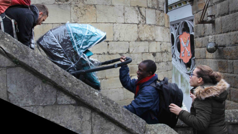 'Helping hand' es el título de esta foto en que dos hombres ayudan a subir el carrito de un bebé por las escaleras, presentada en la galería de imágenes de Envision Kindness.