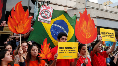 Manifestantes de organizaciones medioambientales participan en una manifestación frente a la embajada de Brasil para exigir más protección de la Amazonía | Reuters