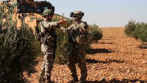 U.S. and Turkish soldiers discuss details during the first-ever combined joint patrol in Manbij, Syria, November 1, 2018. Picture taken November 1, 2018. Courtesy Arnada Jones/U.S. Army/Handout via REUTERS ATTENTION EDITORS -