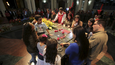 El presidente de Venezuela, Nicolás Maduro (C), junto a familiares del fallecido presidente Hugo Chávez, visitando su tumba durante una ceremonia para conmemorar su 61º cumpleaños en Caracas. Foto proporcionada por el Palacio de Miraflores.