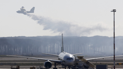 Un avión de Canadair en Italia reparte agua sobre un bosque cerca del Aeropuerto Internacional de Roma - Fiumicino. / REUTERS /Tony Gentil