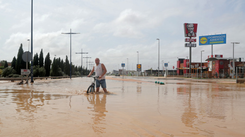 Un hombre camina por una calle inundada tras de fuertes lluvias por la gota fría en San Javier, Murcia.- REUTERS / SERGIO PÉREZ