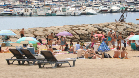 Diverses persones a la platja de Sant Feliu de Guíxols. Imatge publicada el 7 de juliol del 2021